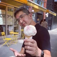 C.Y. Lee holding an ice cream cone outside