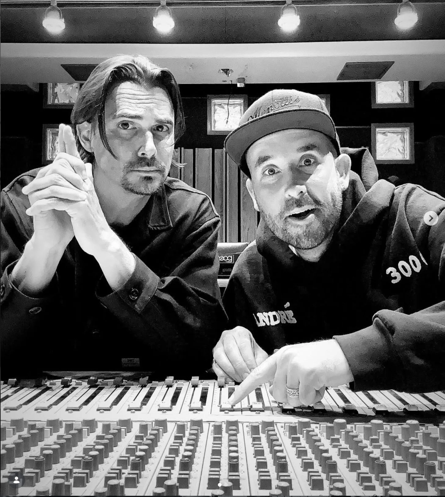 Jonathan Mann and a collaborator at a keyboard in a recording studio