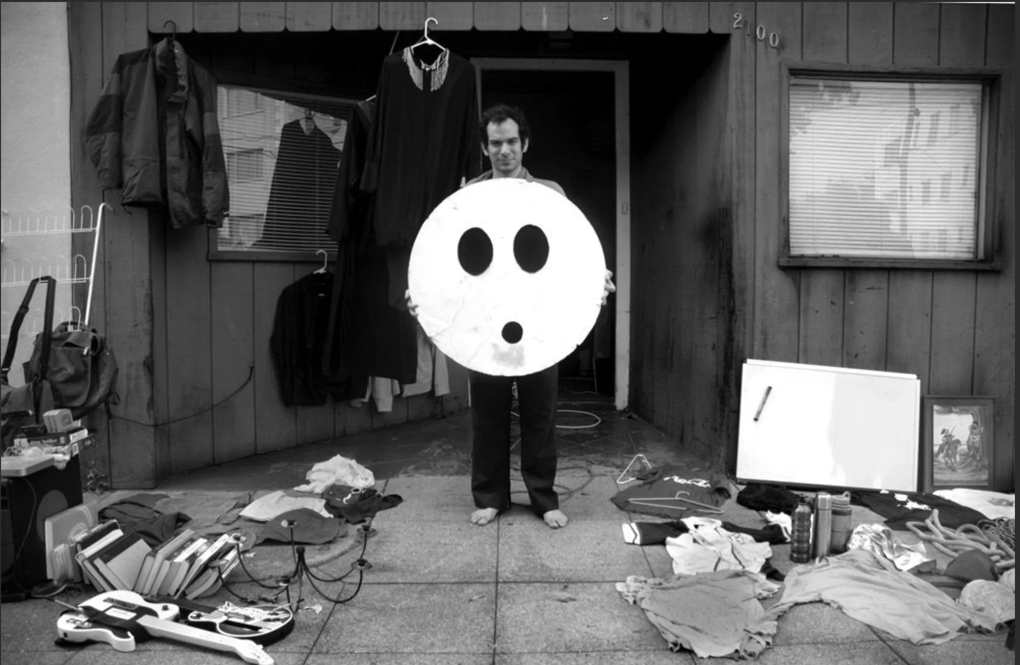 Jonathan Mann in a homemade Song A Day costume, surrounded by recording equipment in the early days
